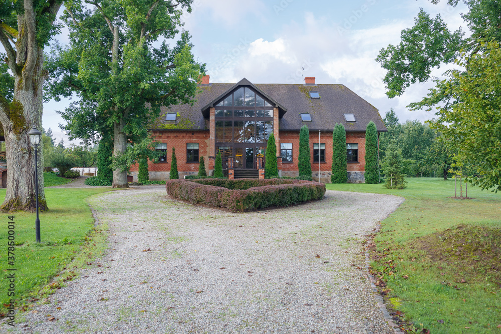 City Talsi, Latvia. Old red brick house and park.