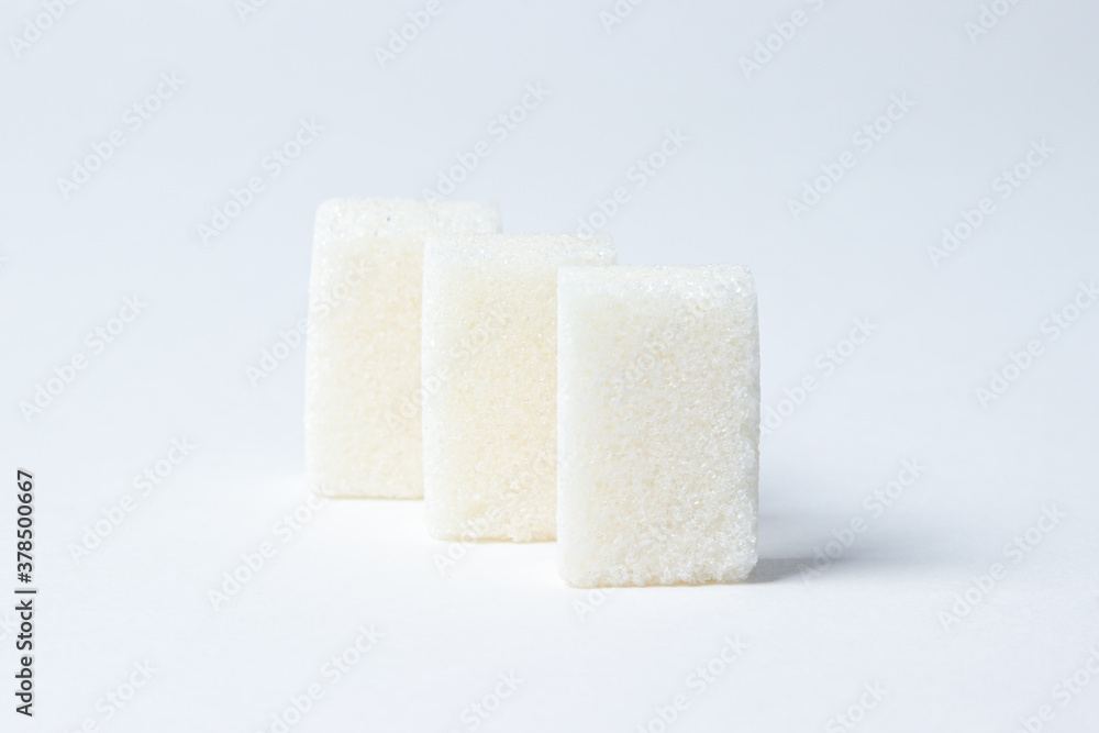 Refined sugar on a white background. White sugar cubes. Refined sugar on a white background. White sugar cubes.