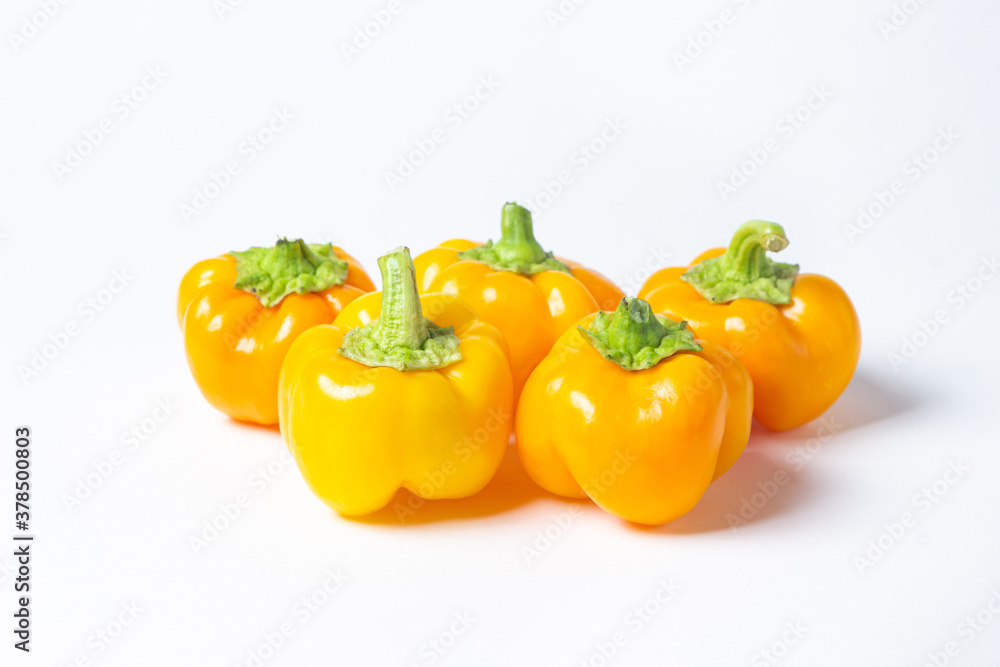 yellow pepper on a white background. Several yellow peppers lie next to each other. Healthy vegetables yellow pepper on a white background. Several yellow peppers lie next to each other. Healthy vegetables