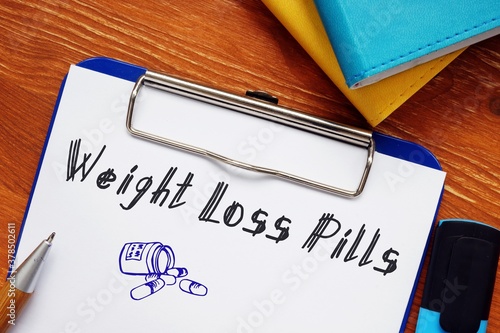 Healthy concept about Weight Loss Pills with sign on the piece of paper. photo