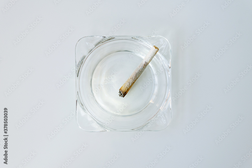 Rolling cigarette turned off in an ashtray. Smoking concept. Marijuana