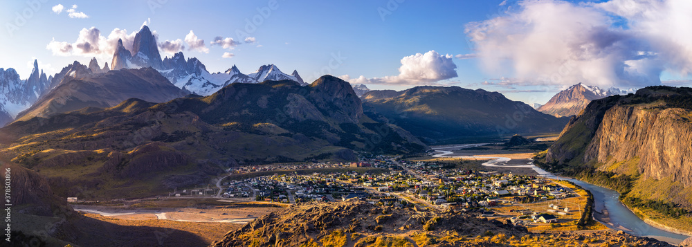 Fototapeta premium Panoramic view at dawn on the village of el chalten and the Patagonian mountains of Cerro Torre and Fitz Roy. Border between Chile and Argentina