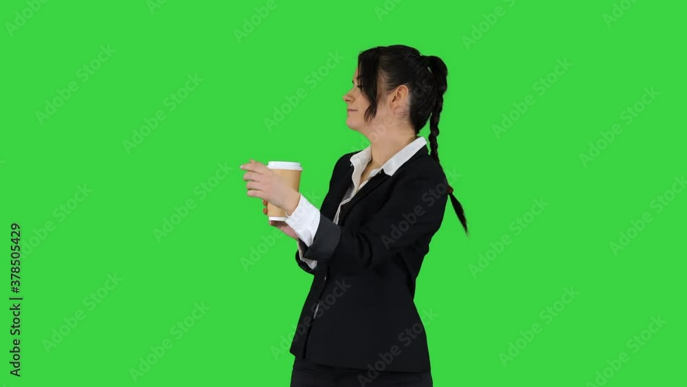 Beautiful young businesswoman having a coffee break with take away coffee and dancing on a Green Screen, Chroma Key. Beautiful young businesswoman having a coffee break with take away coffee and dancing on a Green Screen, Chroma Key.