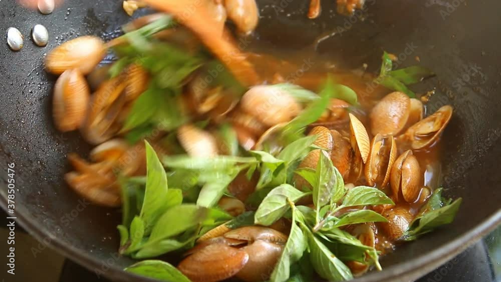 Frying clams with chili paste in pan , in door  Chiangmai  Thailand