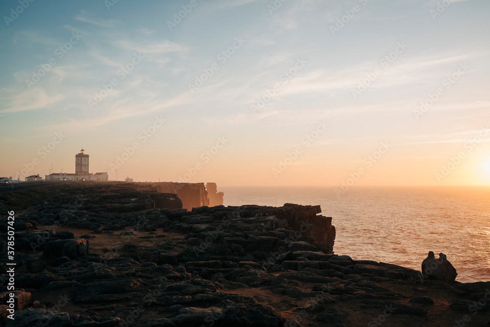 Scenic view lighthouse on cliffs overlooking tranquil seascape at sunset, Peniche, Portugal
Scenic view lighthouse on cliffs overlooking tranquil seascape at sunset, Peniche, Portugal