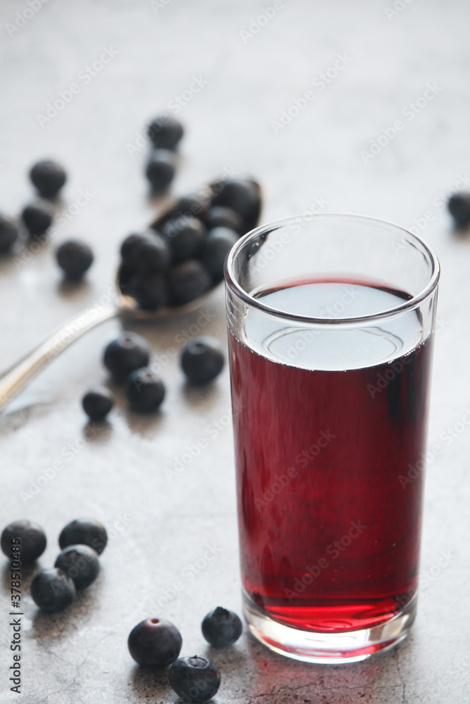 A glass full of blueberry juice A glass full of blueberry juice