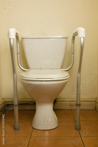 Domestic toilet frame for disabled user,  improves the safety of elderly and disabled users when they use the toilet
