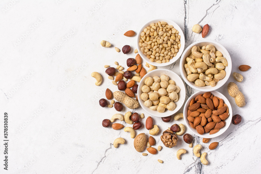White bowls with nuts mix as snack or ingredient for tasty dessert, meal White bowls with nuts mix as snack or ingredient for tasty dessert, meal