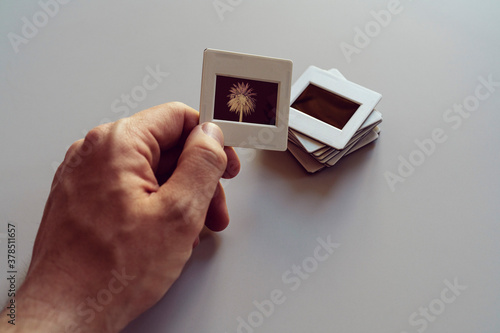 Hand holding photographic slides
