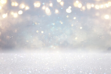 glitter vintage lights background. silver, gold and white. de-focused