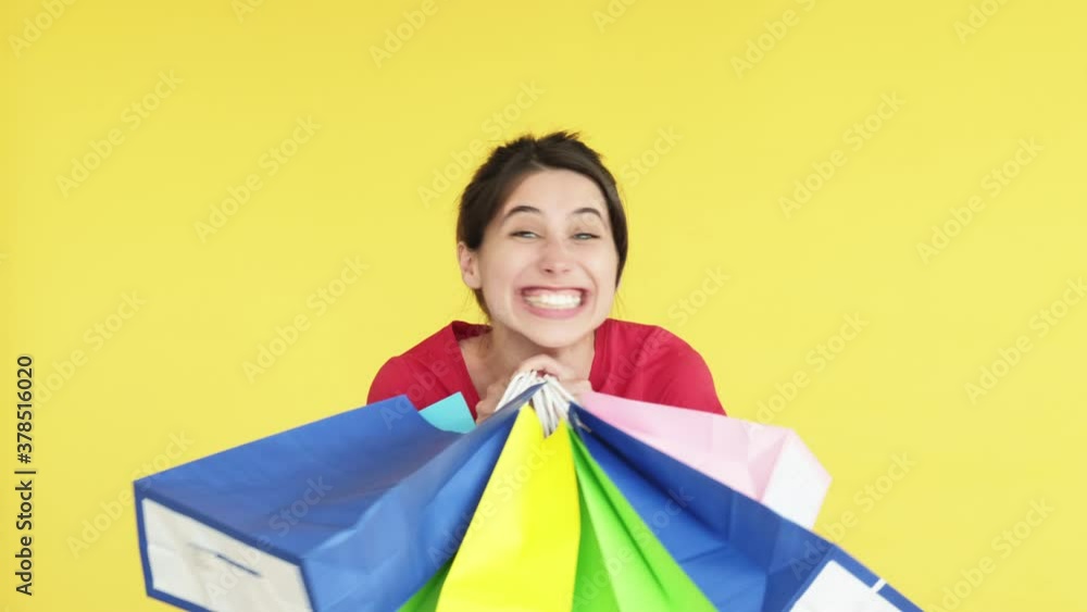 shopaholic lifestyle. Shopping bonus. Excited happy woman getting many colorful bags. Looking at camera isolated on yellow copy space. Sale and discount. Black friday. Holiday gift shopaholic lifestyle. Shopping bonus. Excited happy woman getting many colorful bags. Looking at camera isolated on yellow copy space. Sale and discount. Black friday. Holiday gift
