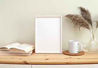 White wooden frame mockup for art, design, photo, empty frame template, boho style interior, books and coffee.