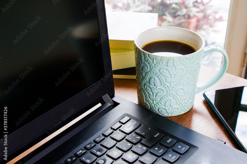 Workspace at home, notebook, mobile device, coffee and plants on the table Workspace at home, notebook, mobile device, coffee and plants on the table