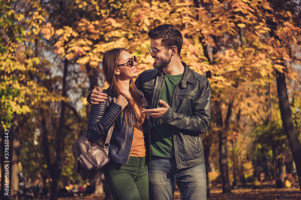 Photo of romantic dream couple speak walk in fall september forest city park wear rucksack jacket sunglass