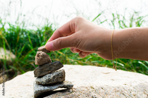 Photography Adding a stone to a balanced stone stack at Bukhansan National Park