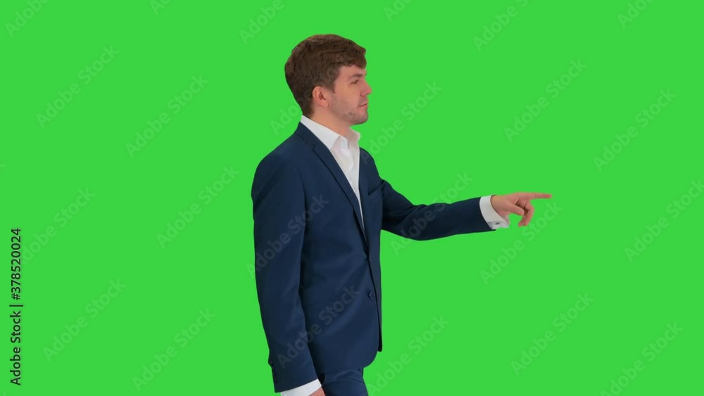 Businessman walking and explaining something to camera on a Green Screen, Chroma Key. Businessman walking and explaining something to camera on a Green Screen, Chroma Key.