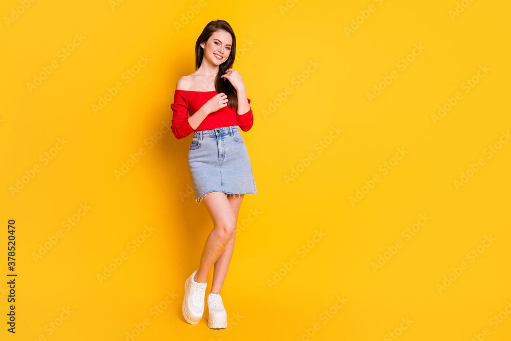 Full length body size view of her she nice attractive pretty lovely slender cheerful cheery girl posing touching silky smooth hair isolated over bright vivid shine vibrant yellow color background Full length body size view of her she nice attractive pretty lovely slender cheerful cheery girl posing touching silky smooth hair isolated over bright vivid shine vibrant yellow color background