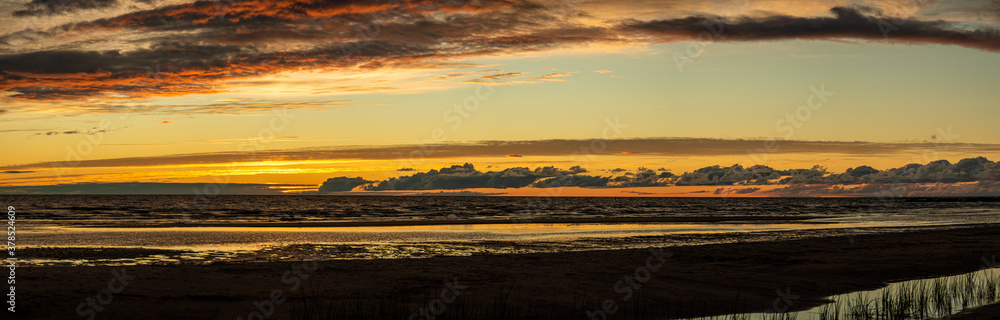 Panorama of the Baltic Sea coast, sand and sun, sunset