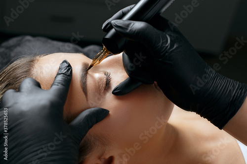 Closeup  shot of a woman applying permanent makeup