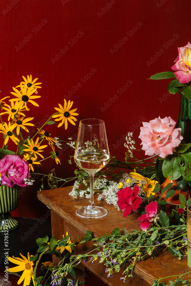 A glass of prosecco among many colorful flowers A glass of prosecco among many colorful flowers