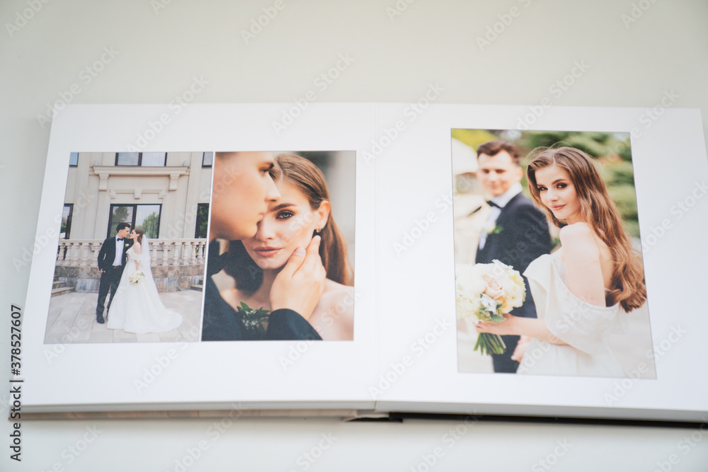 Foto de open wedding photo book. flipping through a photobook with