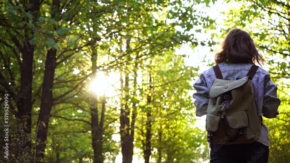 Woman with a backpack walks in the autumn forest. Woman with a backpack walks in the autumn forest.