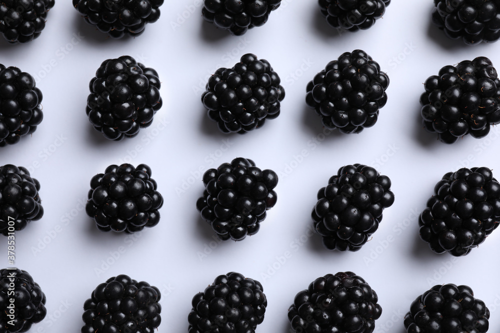 Tasty ripe blackberries on white background, flat lay Tasty ripe blackberries on white background, flat lay