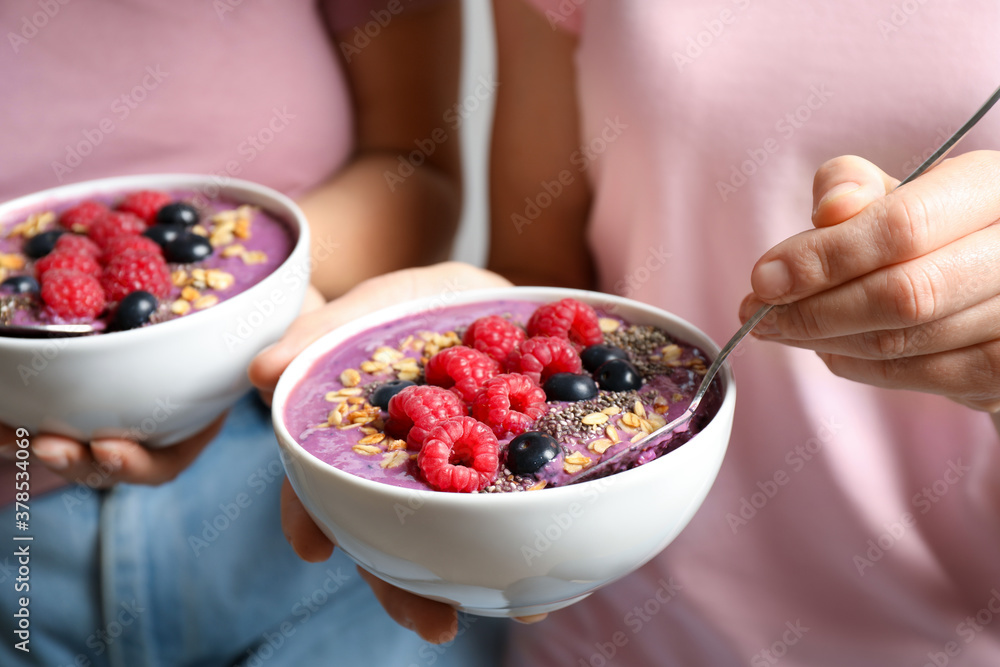 Women with tasty natural acai smoothie, closeup