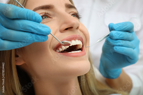 Fototapeta Naklejka Na Ścianę i Meble -  Doctor examining patient's teeth, closeup. Cosmetic dentistry