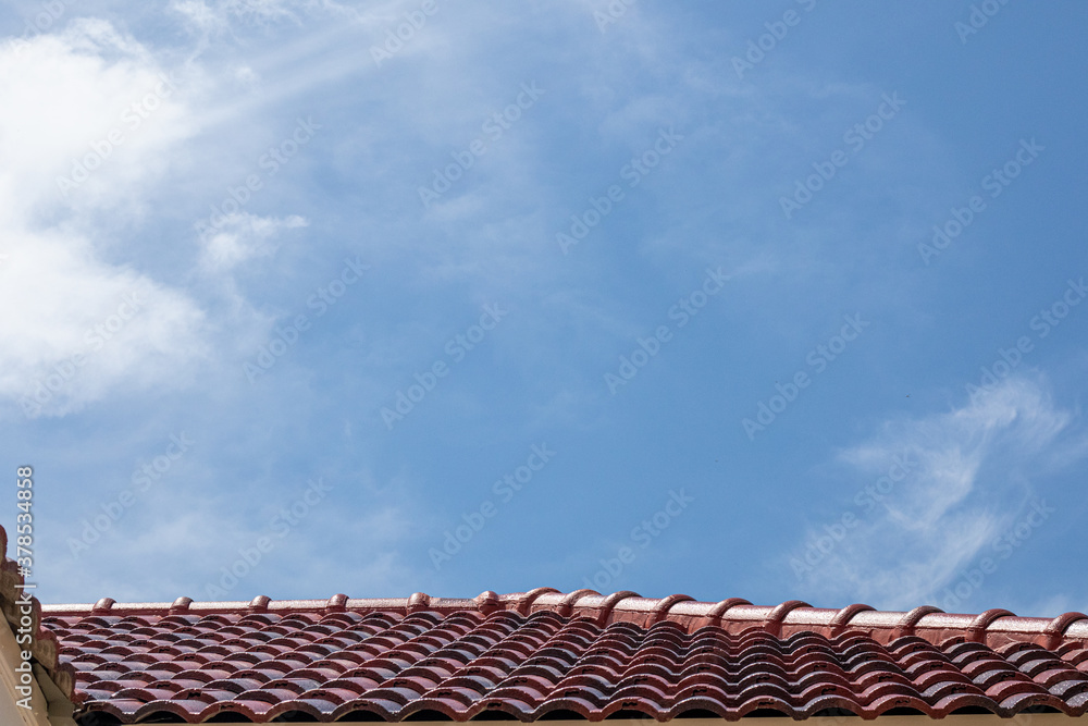 Gray tile roof of construction house with blue sky. Gray tile roof of construction house with blue sky.