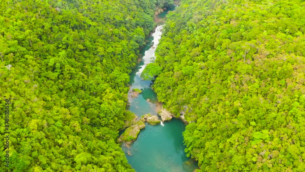 Aerial drone of Tropical Loboc river in the rainforest. Mountain river flows through green forest. Bohol, Philippines. Aerial drone of Tropical Loboc river in the rainforest. Mountain river flows through green forest. Bohol, Philippines.