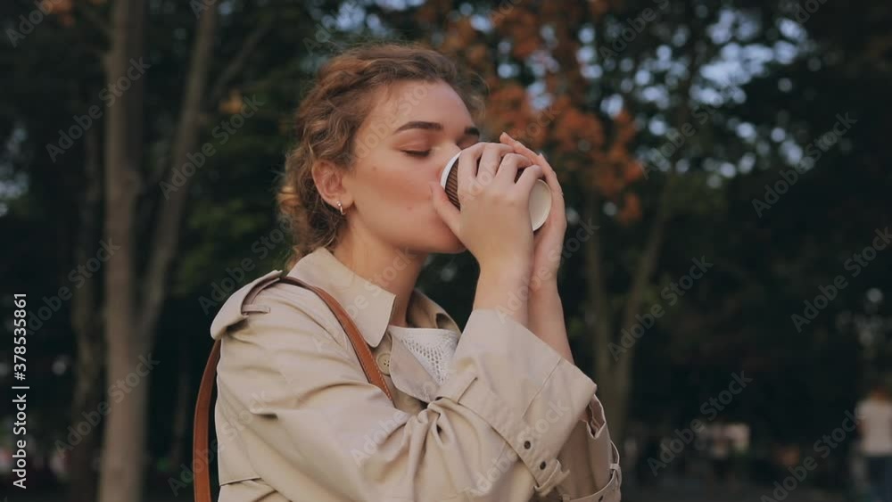 Woman drinking delicious takeaway coffee at the autumn park Woman drinking delicious takeaway coffee at the autumn park