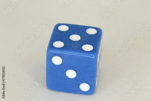 a blue dice showing a five