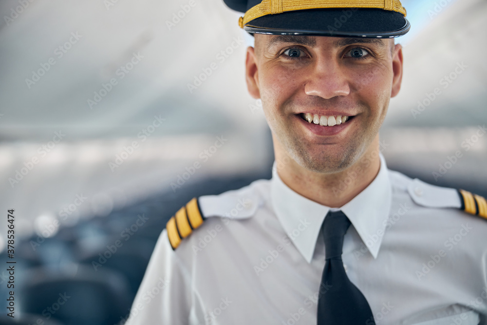 Happy toothy smile of man in the aircraft Happy toothy smile of man in the aircraft
