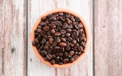 natural black coffee beans in a ceramic plate