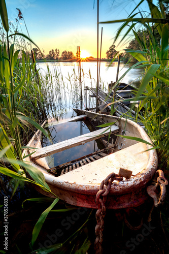 Fototapeta Naklejka Na Ścianę i Meble -  Lake And Old Rowing Fishing Boat At Beautiful Sunrise.