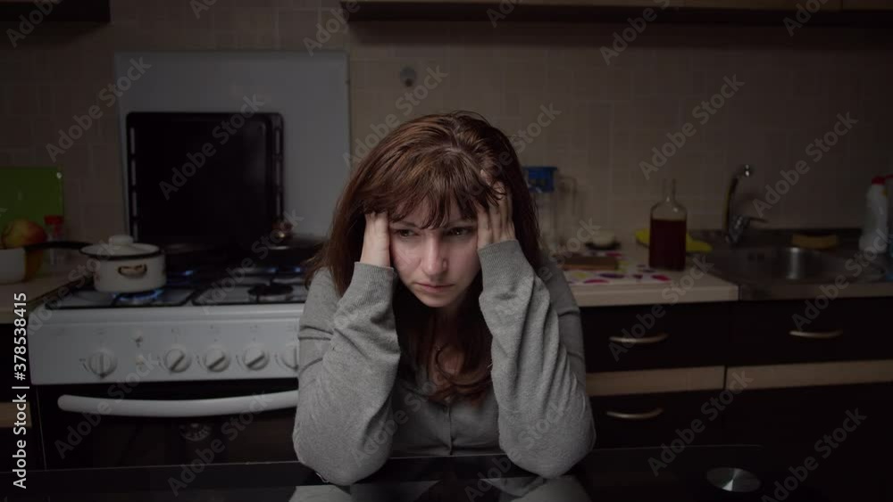 sad tired woman sitting in the kitchen at home, deadlock sad tired woman sitting in the kitchen at home, deadlock