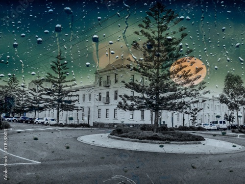 rainy evening  city landscape with the big red moon at the back .  Location Port Melbourne Victoria Australia