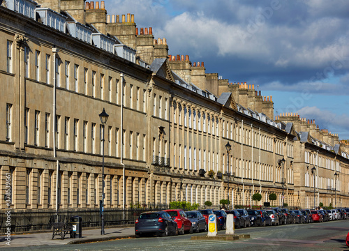 Fototapeta Naklejka Na Ścianę i Meble -  Row of terraced housing along Great Pulteney Street in Bath Spa at sunset
