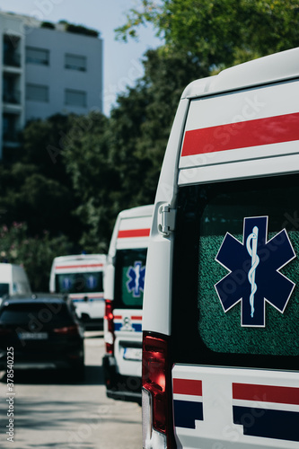 Obraz na plátně Vertical shot of the rear side of a white ambulance van, parked in Split, Croatia amid the coronavirus outbreak