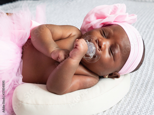 Close up  a baby girl sleeping with dummy in her mouth