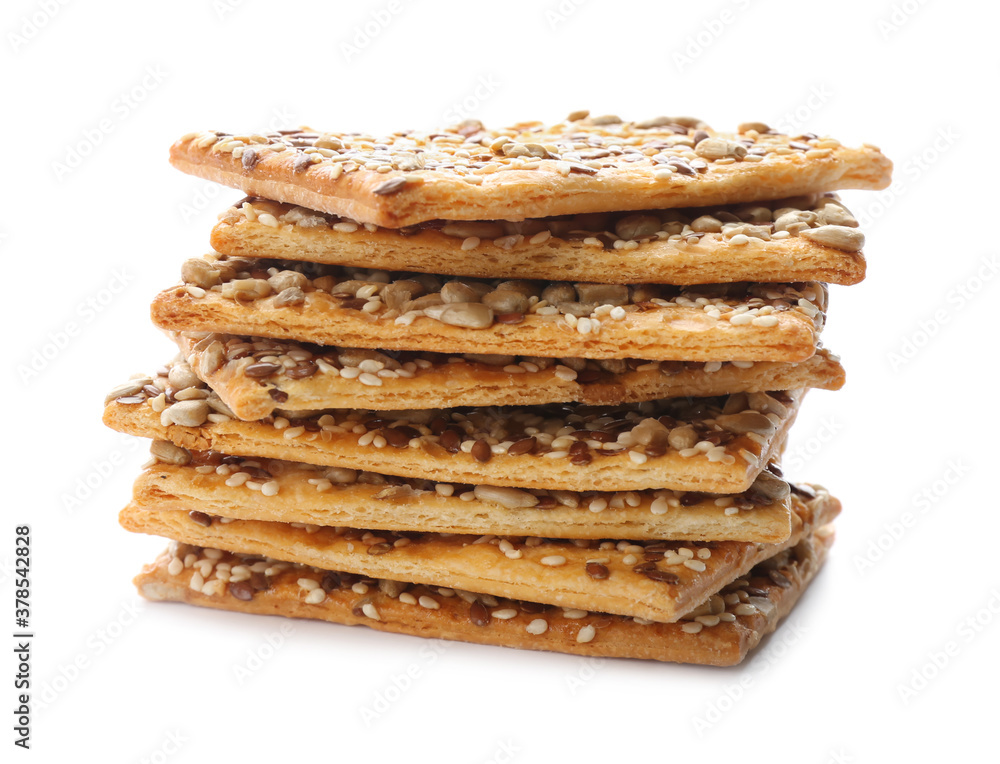 Stack of delicious crispy crackers with different seeds isolated on white Stack of delicious crispy crackers with different seeds isolated on white