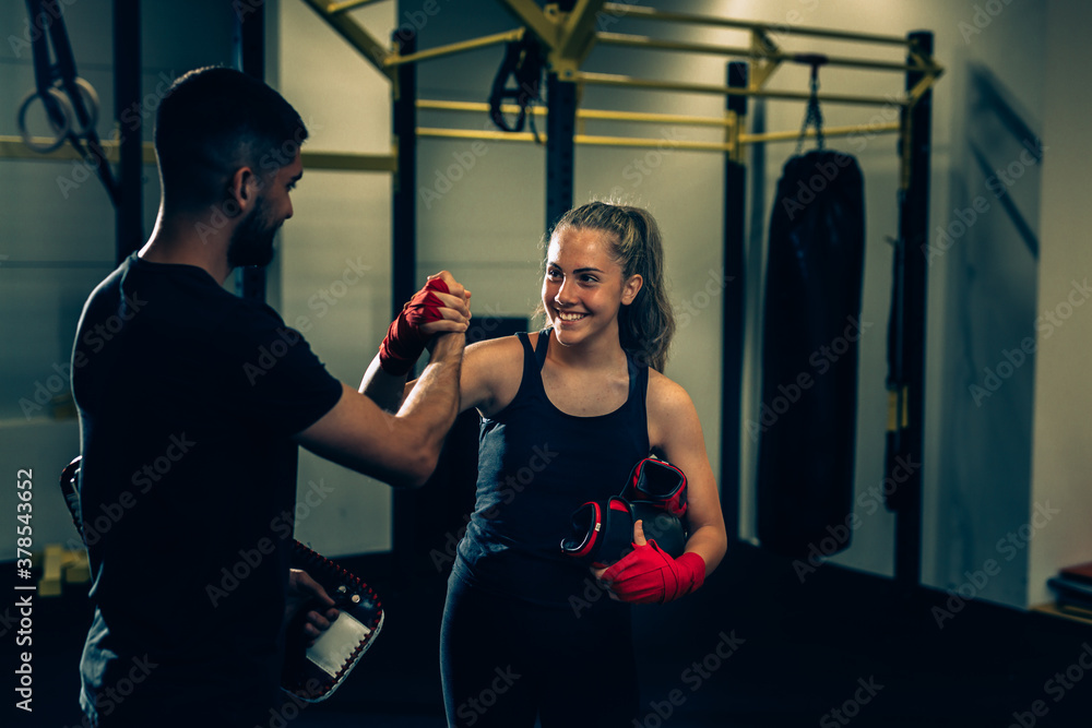 personal trainer and woman handshake