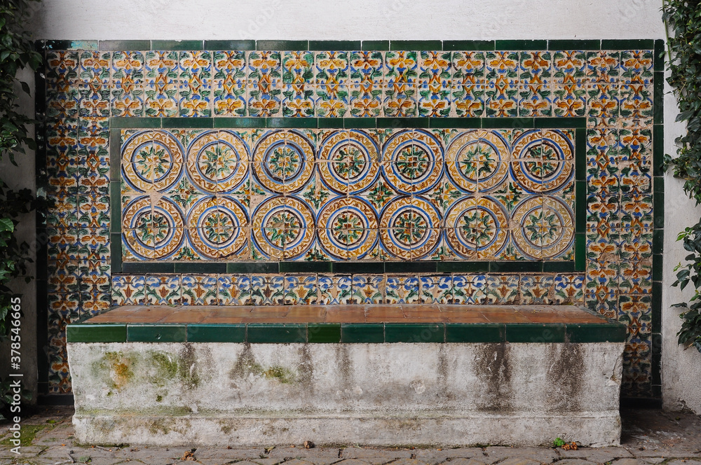 Alcazar of Seville, Spain. Bench decorated with ceramic tiles (azulejos) in a courtyard
