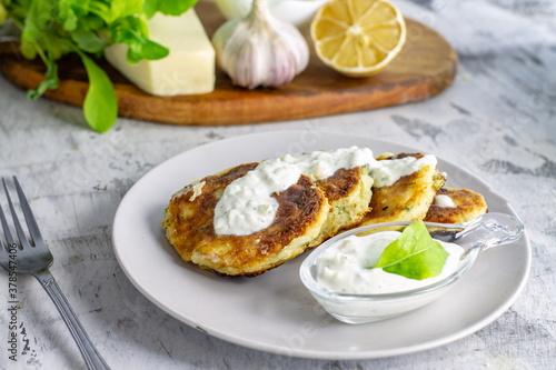 unsweetened cottage cheese pancakes with white sauce on a light background