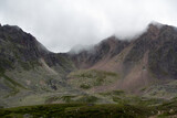 Mountain range in the clouds. Mountain pass in the fog. Pass Pastushiy (3244 meters above sea level), Caucasus.