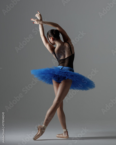Young beautiful ballerina is posing in studio