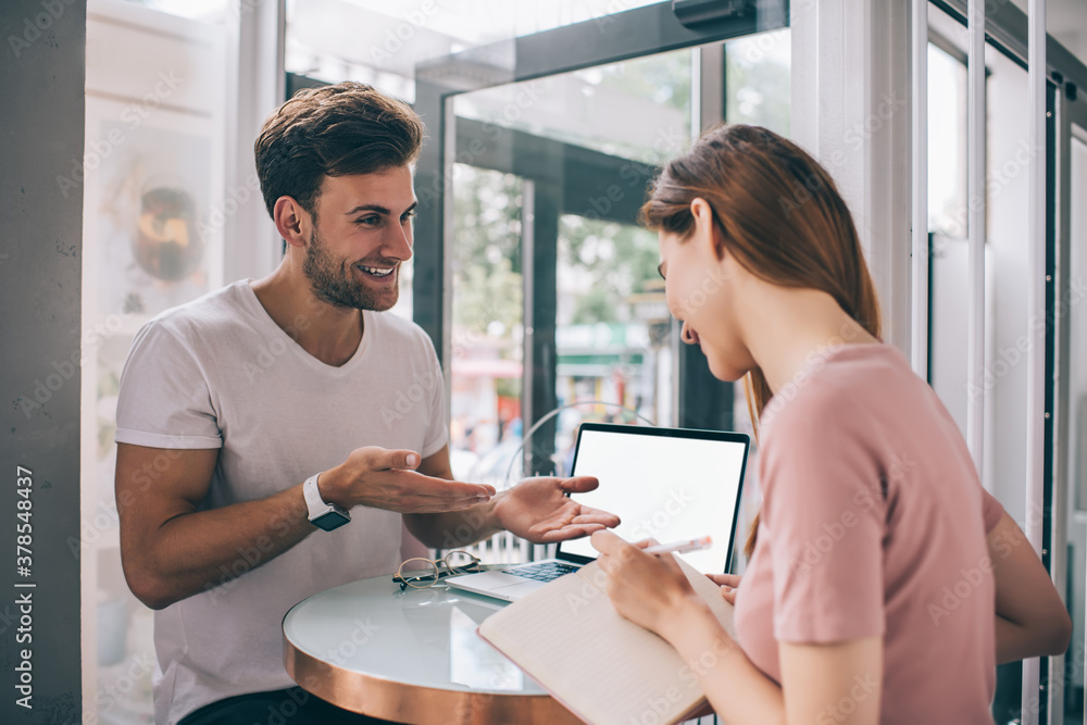 Charismatic man explaining coworker plan of project Charismatic man explaining coworker plan of project