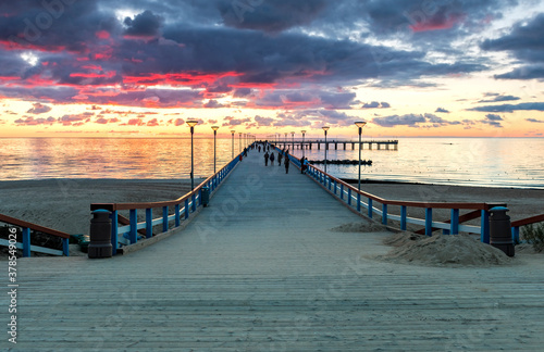 Colorful sunset on walking marine pier at the Baltic Sea tourist resort,  Europe
