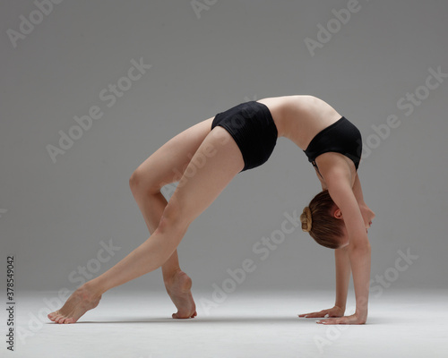 Fototapeta Naklejka Na Ścianę i Meble -  Young beautiful yoga woman is posing in studio.